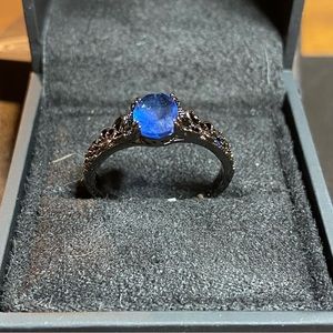 Beautiful ring with sapphire stone on a black band size 9